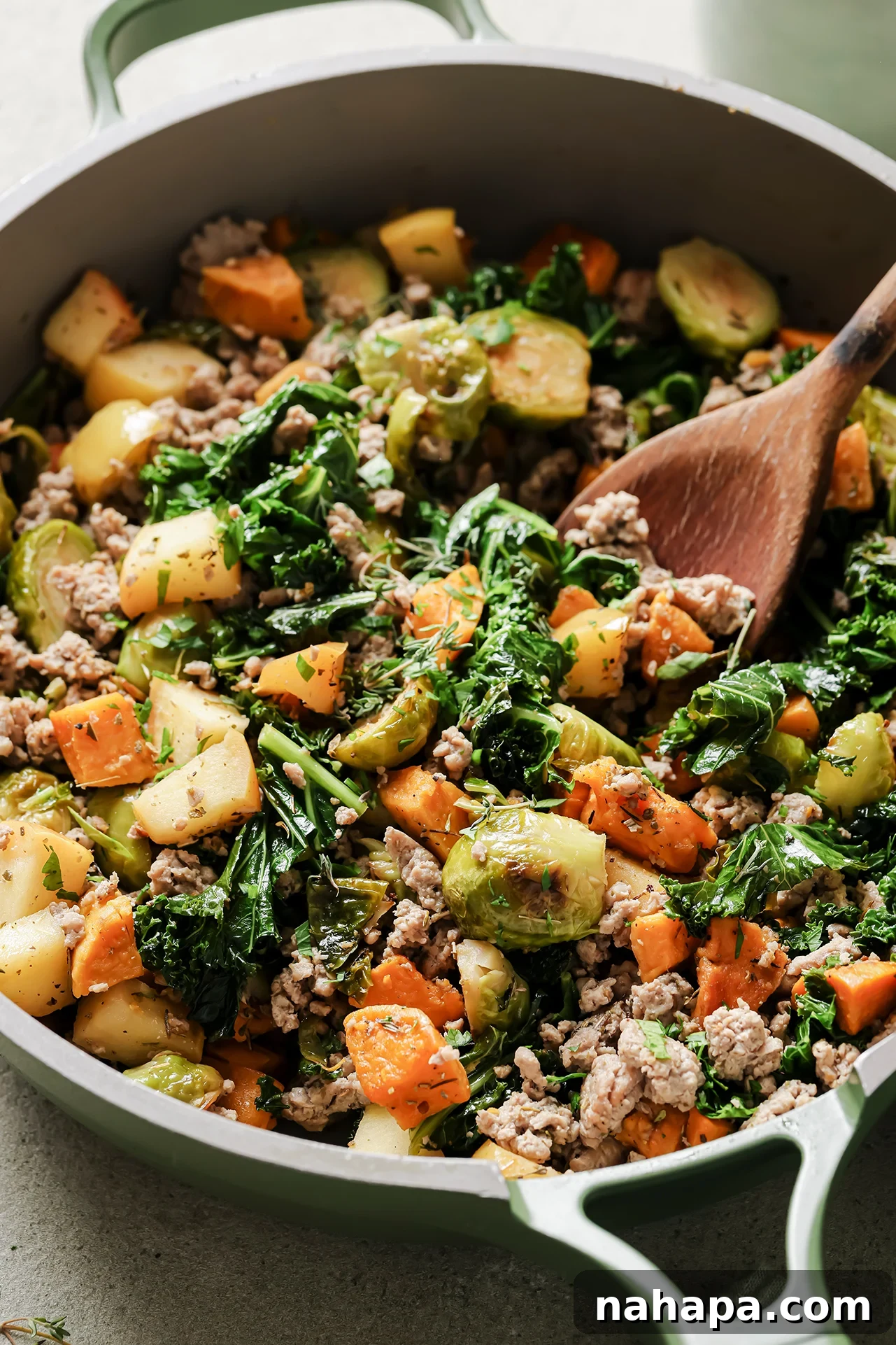 A vibrant skillet of turkey and sweet potato breakfast hash, ready to be served.