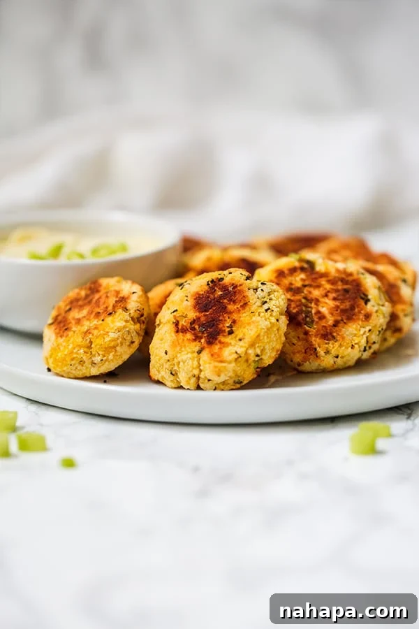 Crispy golden spaghetti squash nuggets on a parchment-lined baking sheet, ready to be served as a healthy snack.