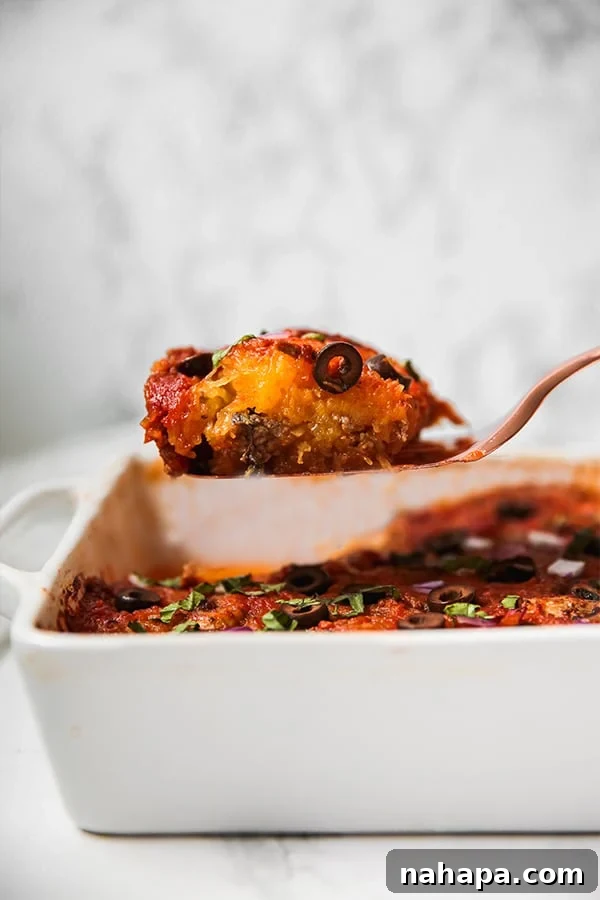 A close-up shot of spaghetti squash pizza casserole in a baking dish, freshly baked and garnished.