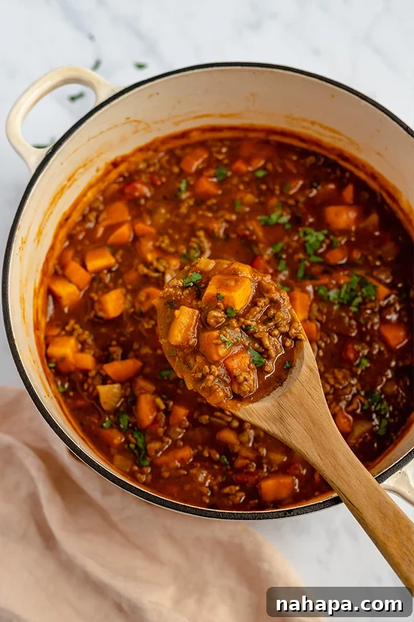 Hearty Paleo Pumpkin Chili cooking in a pot on the stove