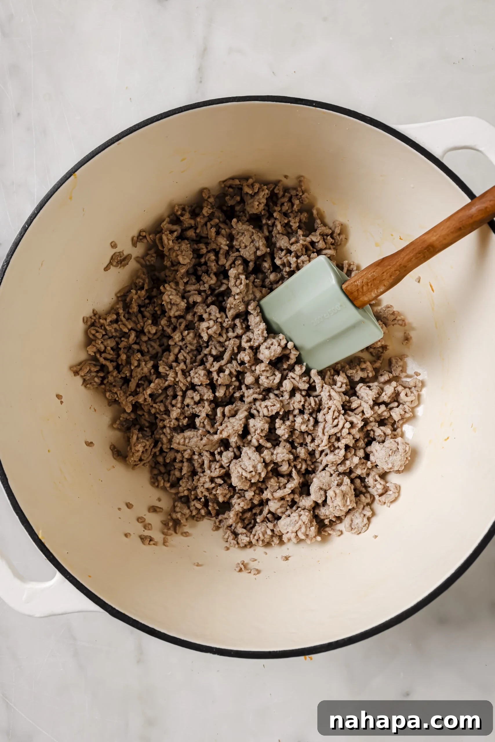 One-Pot Gluten-Free Egg Roll Soup 4 Cooked ground pork crumbled in a large pot, ready for the next step of soup preparation.