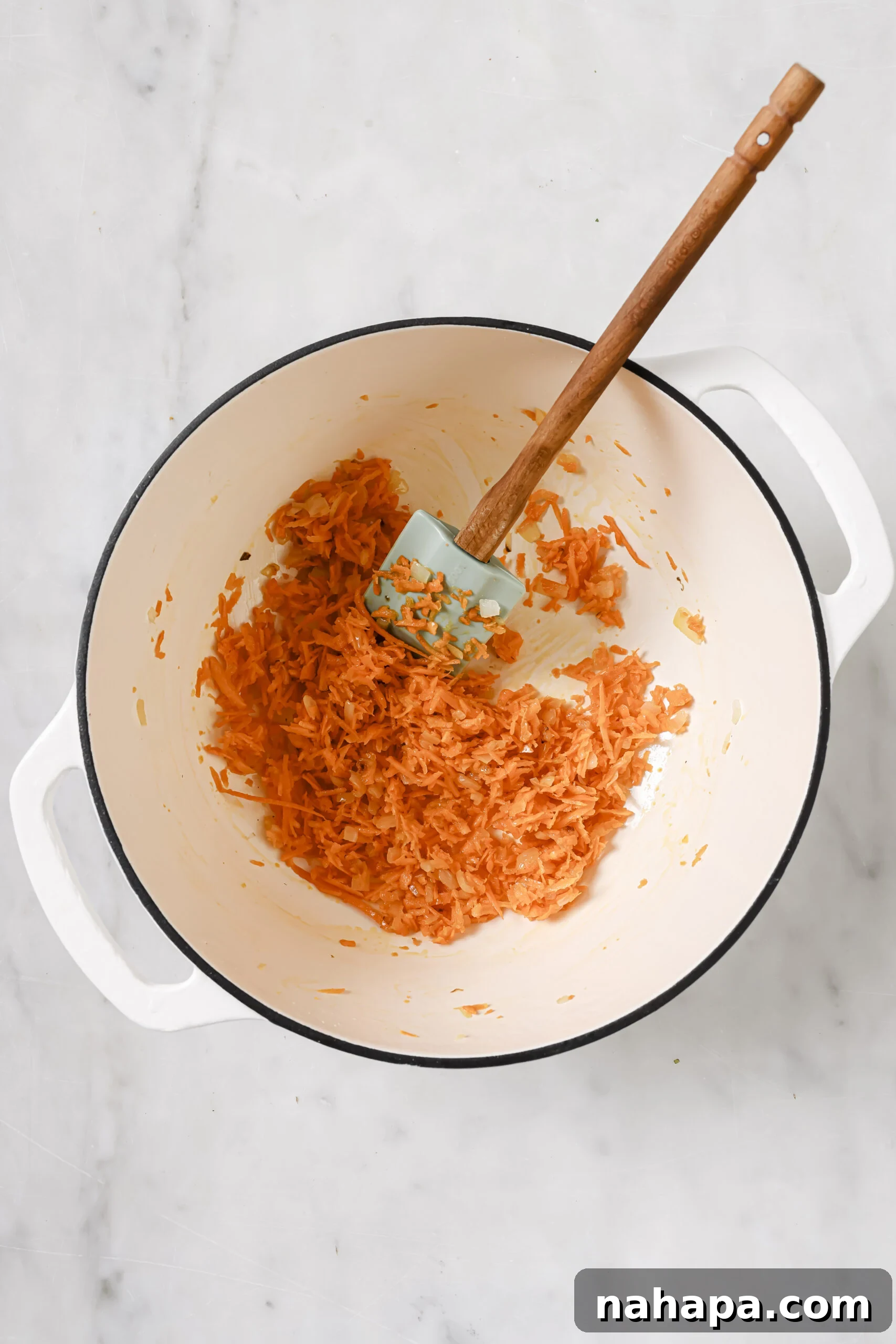 One-Pot Gluten-Free Egg Roll Soup 5 Shredded carrots being cooked in a white pot, sautéing gently.