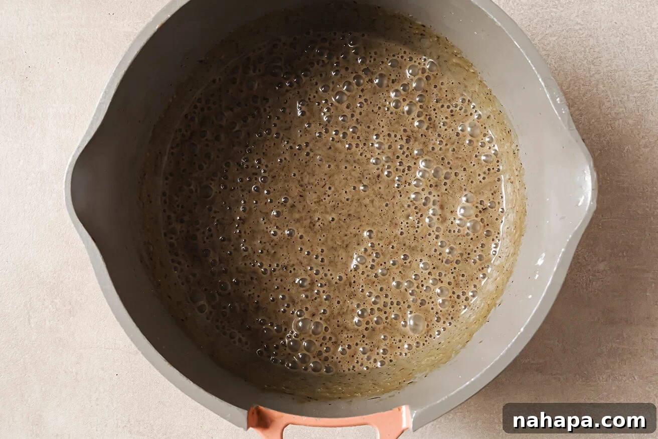 Comforting Gluten Free Green Bean Bake 5 Cream of mushroom soup blended in a pot.