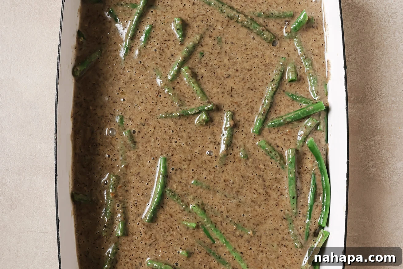 Comforting Gluten Free Green Bean Bake 7 Green beans and mushroom soup in a casserole dish.