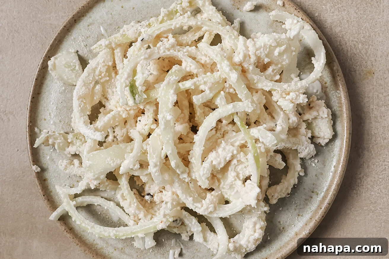 Comforting Gluten Free Green Bean Bake 8 Onions tossed in batter, ready to be fried.