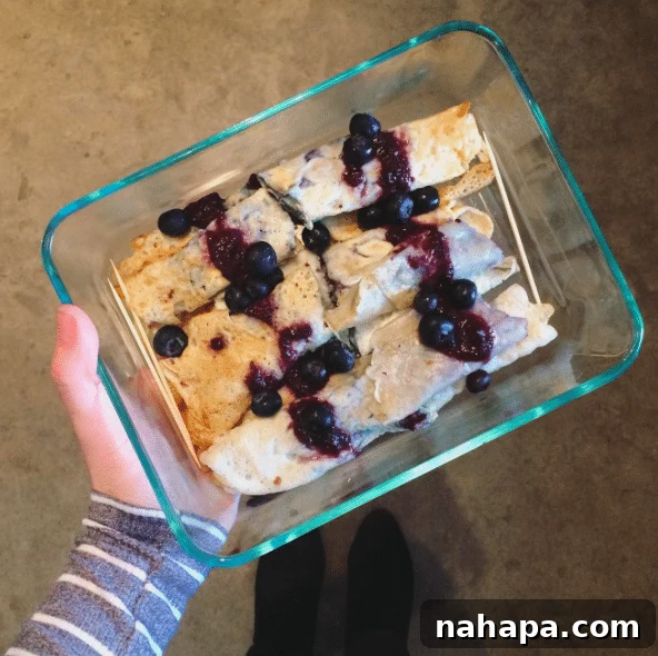 Homemade paleo crepes with blueberry sauce, a delicious and carefully prepared dish for the potluck.