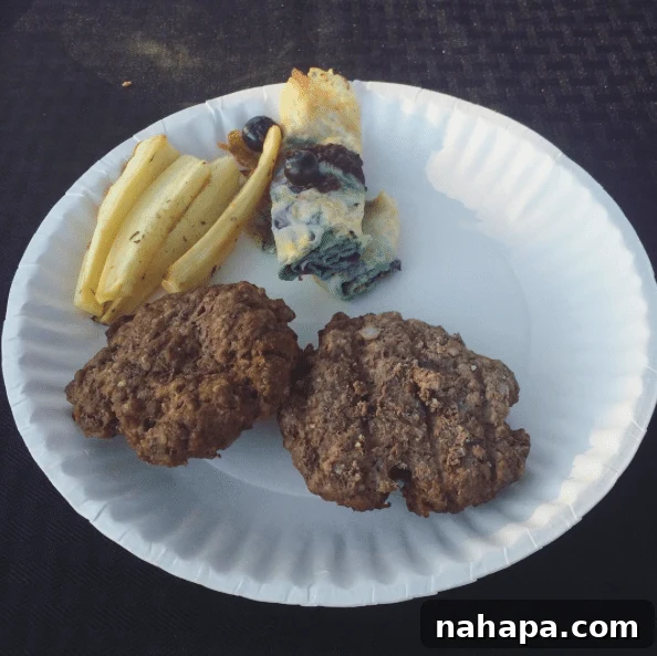 The author's plate with a grass-fed burger, parsnip fries, and paleo crepes, demonstrating thoughtful meal planning for dietary needs.