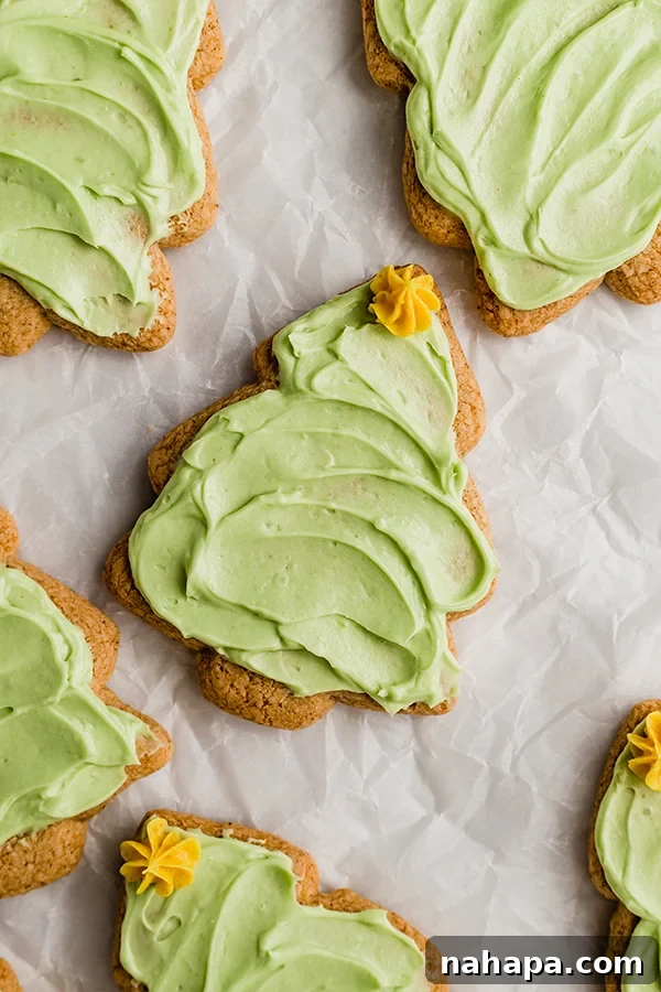 Festive Christmas Cut-Out Sugar Cookies, beautifully decorated with green frosting and yellow stars.