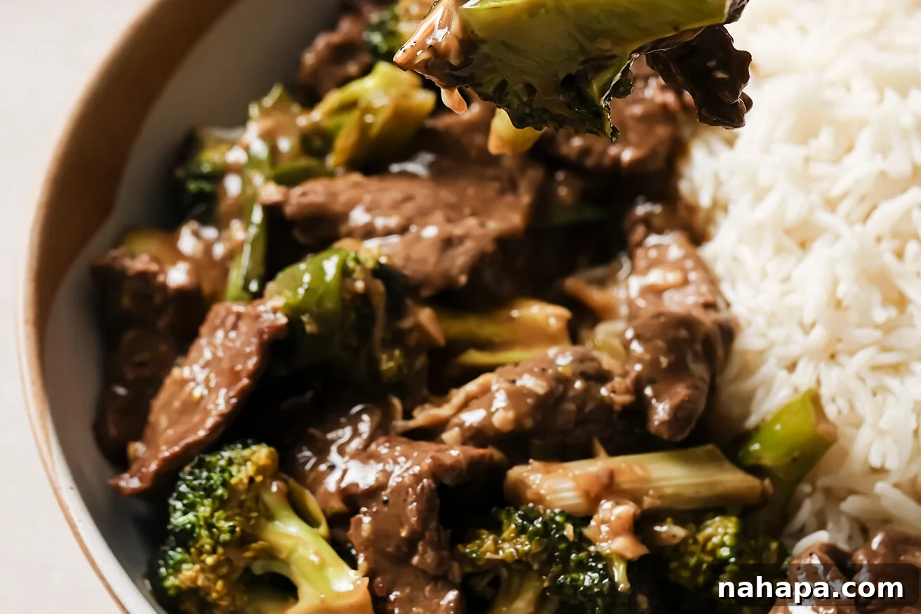Gluten free mongolian beef on a plate with a fork.