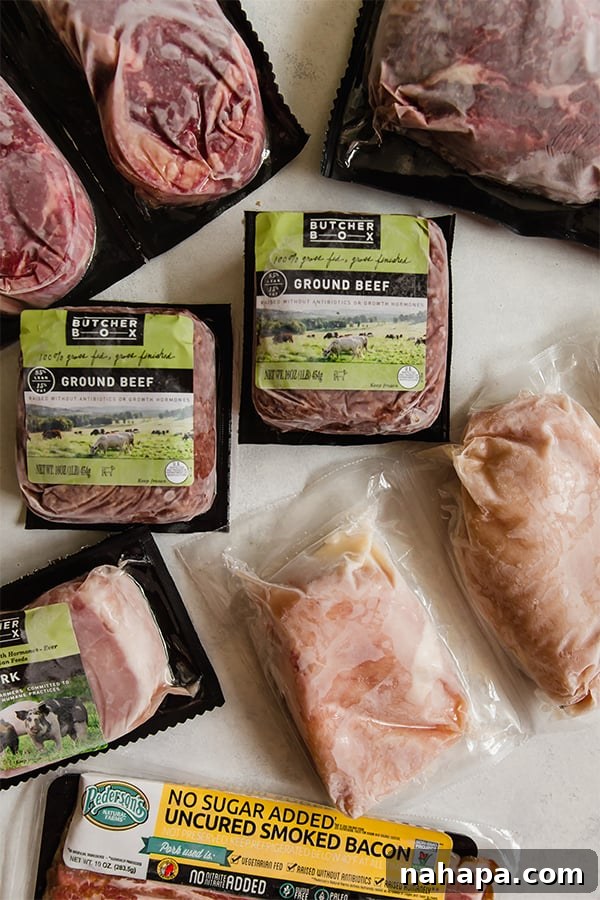 Assorted meats from Butcher Box frozen out on a counter.