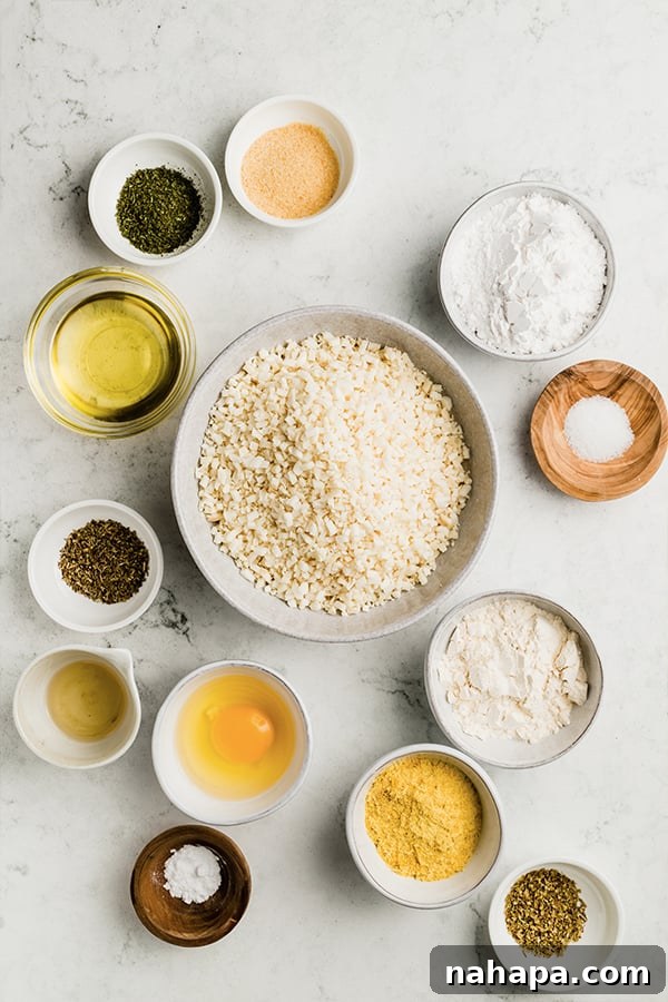 Grain-Free and Dairy-Free Cauliflower Breadsticks: Paleo and AIP Compliant 3 A selection of fresh ingredients, including riced cauliflower, olive oil, and various herbs, laid out on a table, ready for making breadsticks.