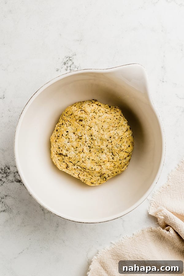 Grain-Free and Dairy-Free Cauliflower Breadsticks: Paleo and AIP Compliant 4 A bowl containing the mixed dough for cauliflower breadsticks, showcasing its texture before shaping.