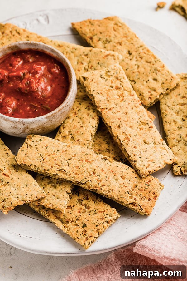 Grain-Free and Dairy-Free Cauliflower Breadsticks: Paleo and AIP Compliant 6 A beautifully arranged plate of freshly baked cauliflower breadsticks, ready for serving with a bowl of dipping sauce.