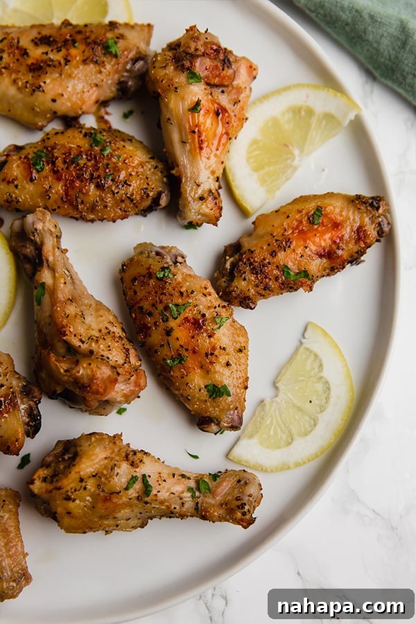 Crispy, golden lemon pepper chicken wings, perfectly seasoned and ideal for a healthy game day snack, compliant with paleo and Whole30 diets.