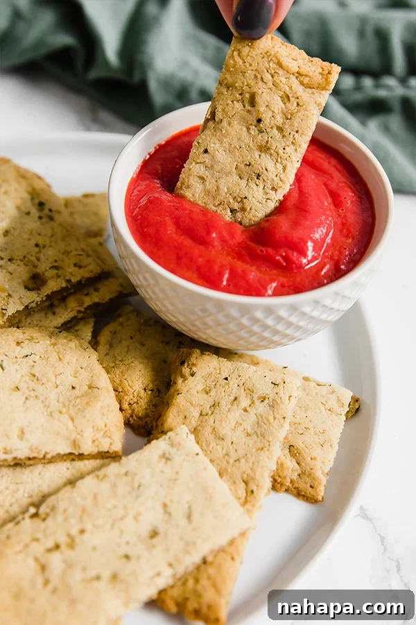 Golden brown cauliflower breadsticks, dairy-free and grain-free, perfect for dipping in a compliant marinara sauce.