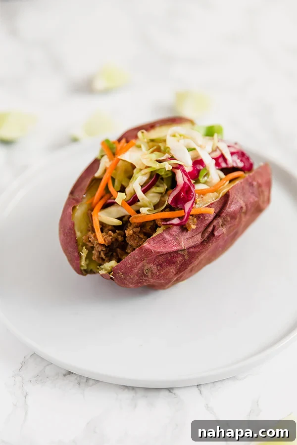 Asian sloppy joe in a baked Japanese sweet potato, topped with fresh green onions.