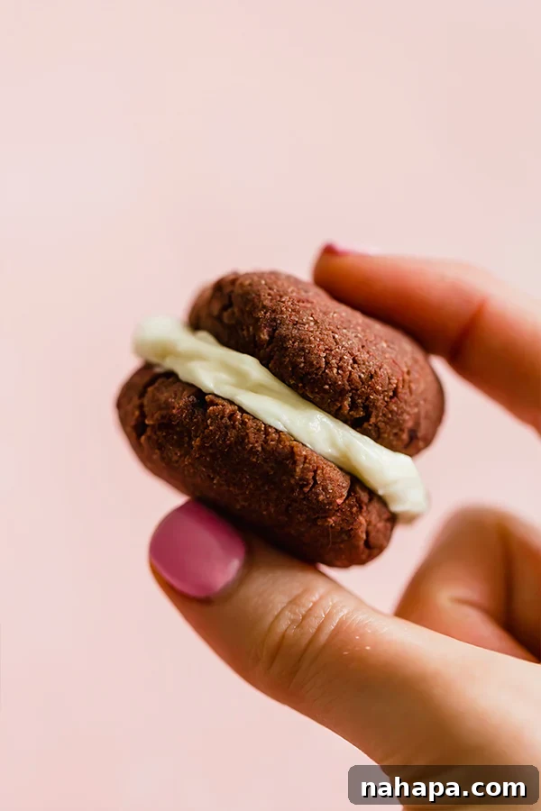 Close-up of a naturally colored red velvet whoopie pie with creamy filling.
