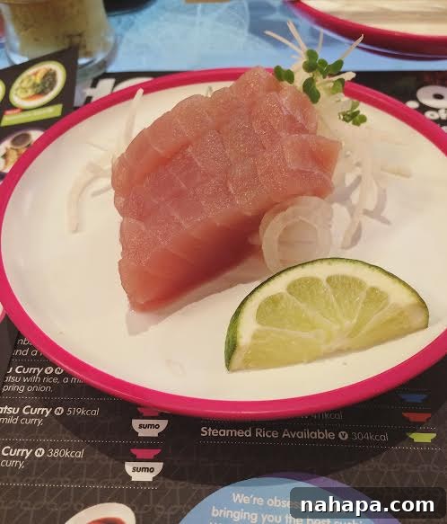 Two plates of fresh tuna sashimi, a clean and compliant meal choice at an airport sushi bar, perfect for restricted diets.