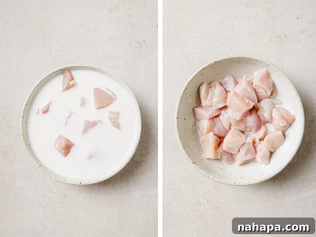 Chicken marinating in coconut milk in a bowl