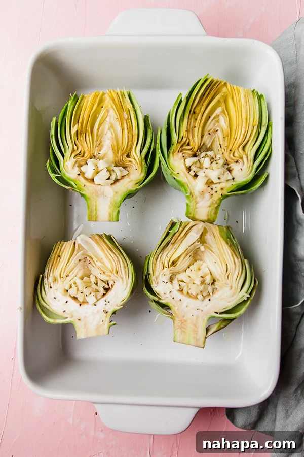 Two halves of an oven-baked artichoke seasoned with garlic and lemon