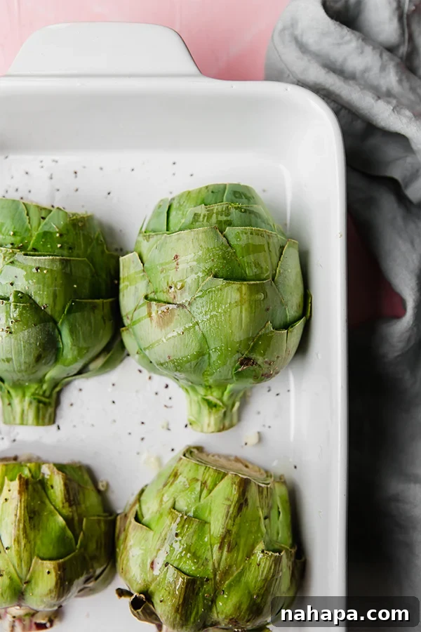 Artichoke halves ready for baking, with garlic cloves
