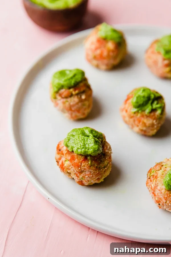 Closeup of salmon meatballs with fresh herbs