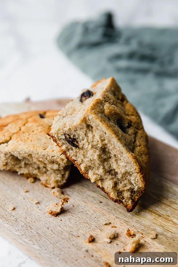 A beautifully baked loaf of paleo Irish soda bread, scored with a cross, ready to be sliced and enjoyed.