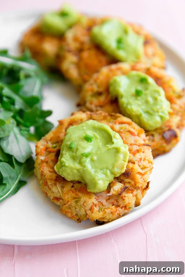 Delicious and healthy Carrot Bacon Breakfast Fritters stacked on a plate, ready to be served for a paleo, whole30, or AIP-friendly meal.