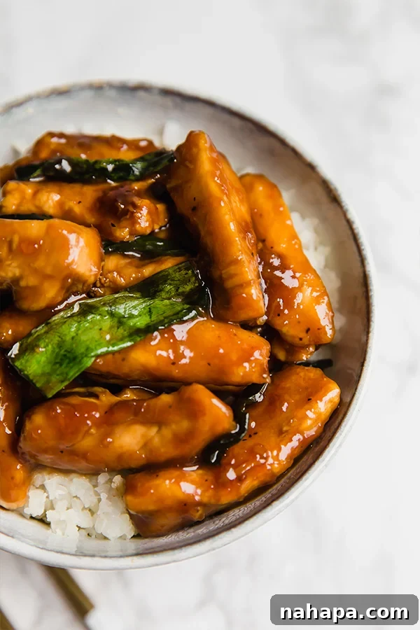 Savory Paleo Mongolian Chicken stir-fry garnished with fresh green onions