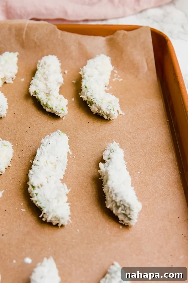Delicious baked avocado fries served with a creamy dipping sauce and fresh cilantro