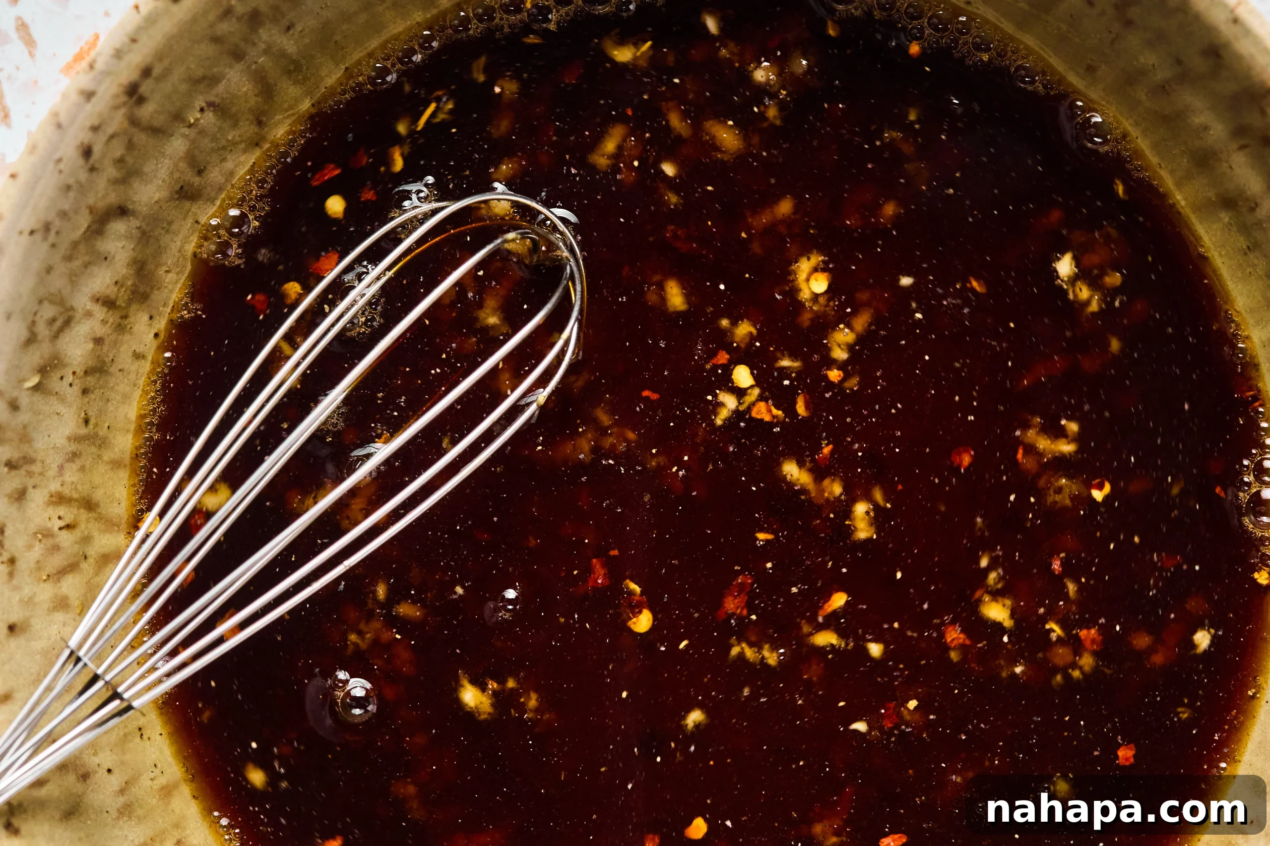 A bowl of marinate after being whisked together, ready for chicken.