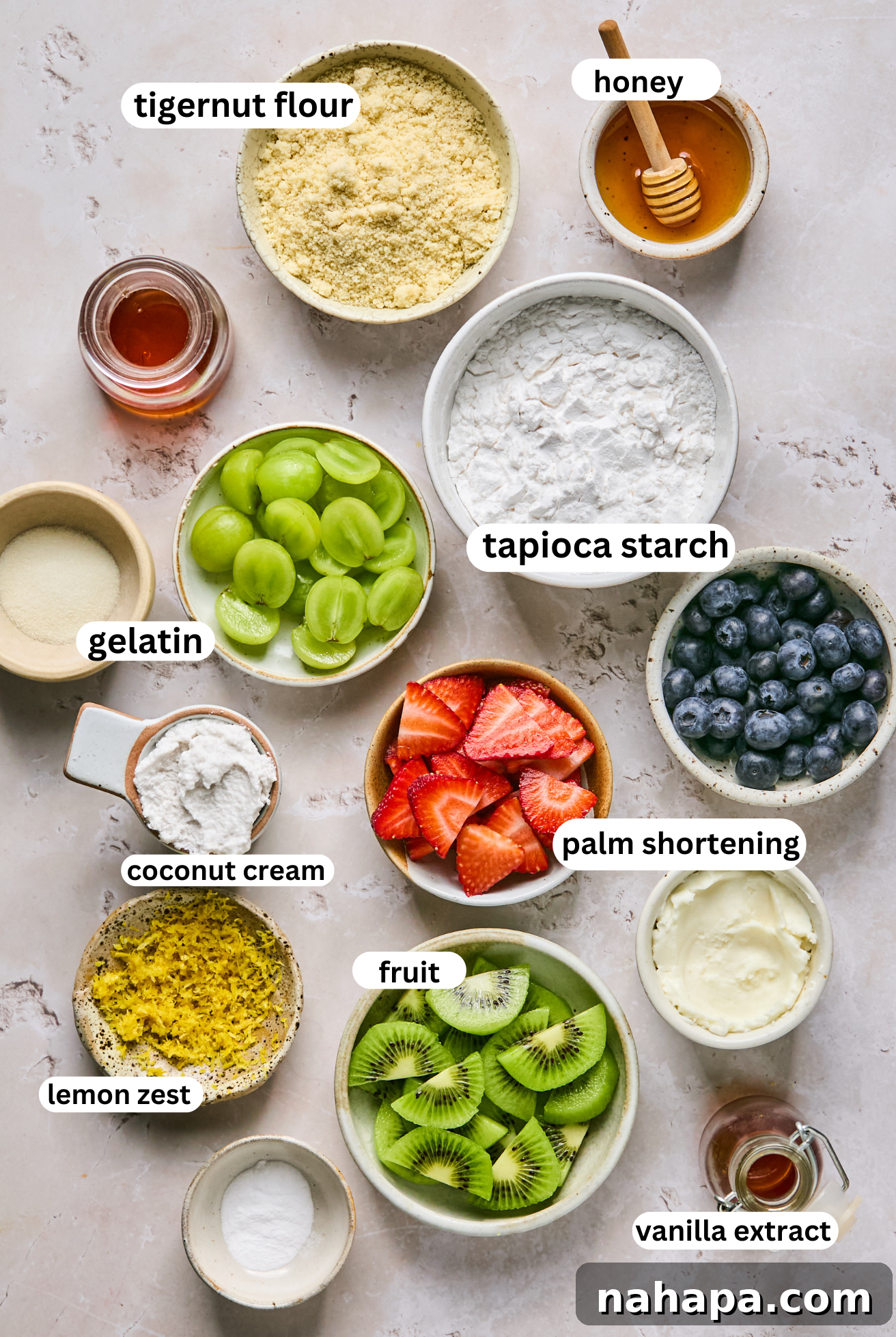 Sugar cookie fruit pizza ingredients displayed in separate bowls for clarity.
