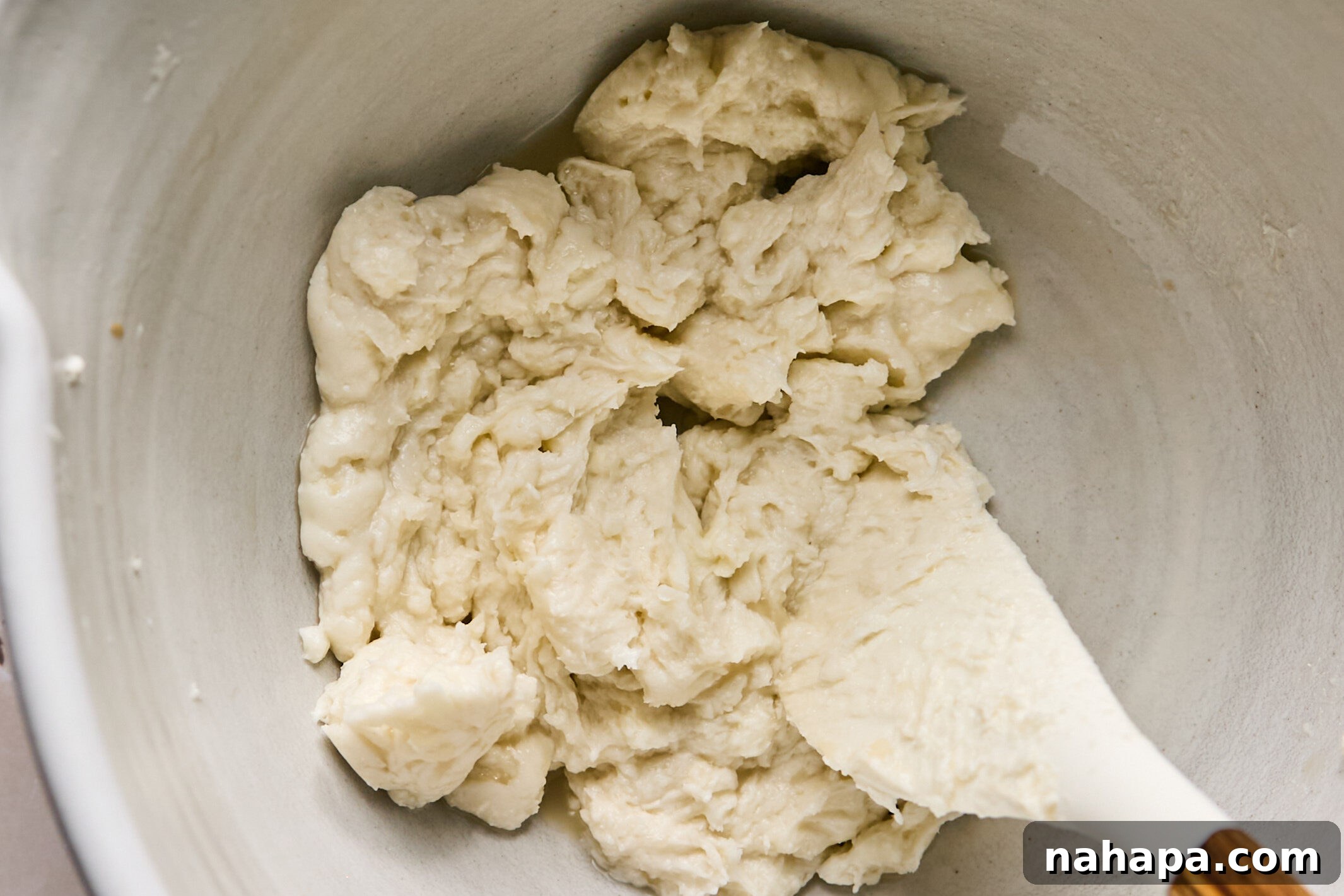 Frosting ingredients being stirred together until smooth and creamy.