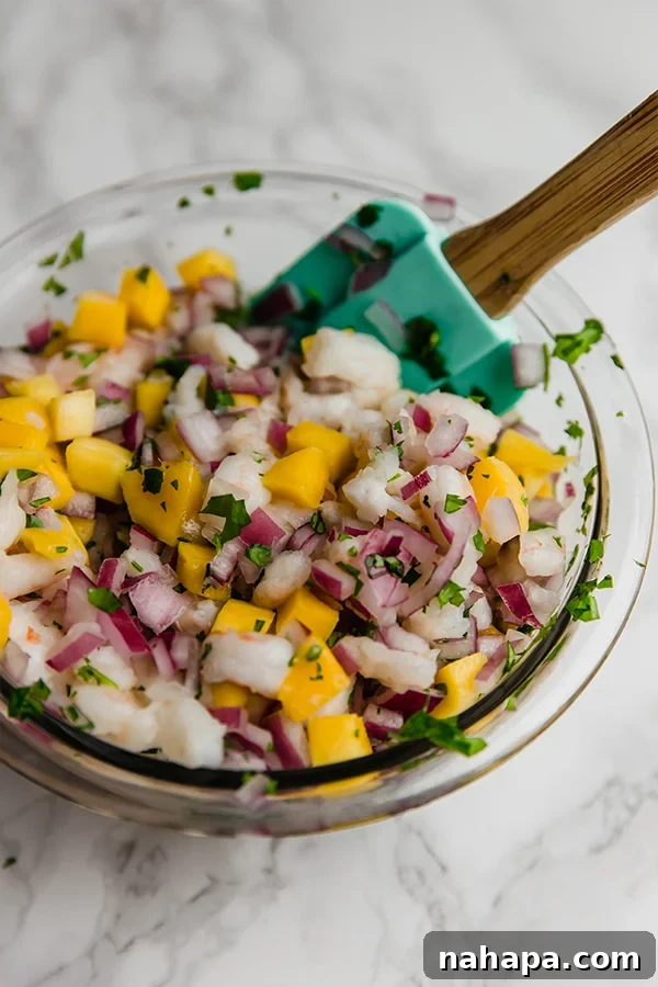 Close-up of mango shrimp ceviche with avocado and cilantro, ready to be served.