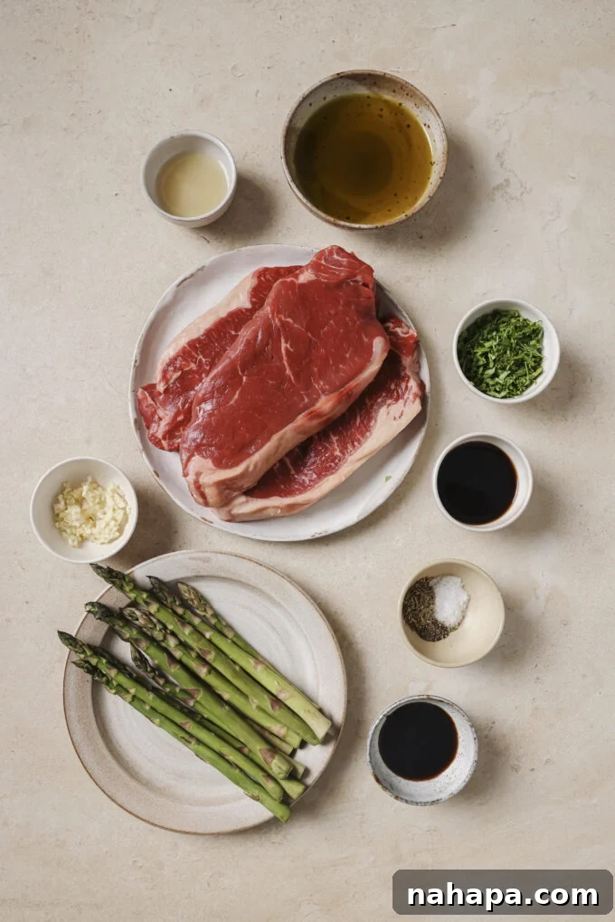Close-up of marinated garlic balsamic steak bites with asparagus in a skillet