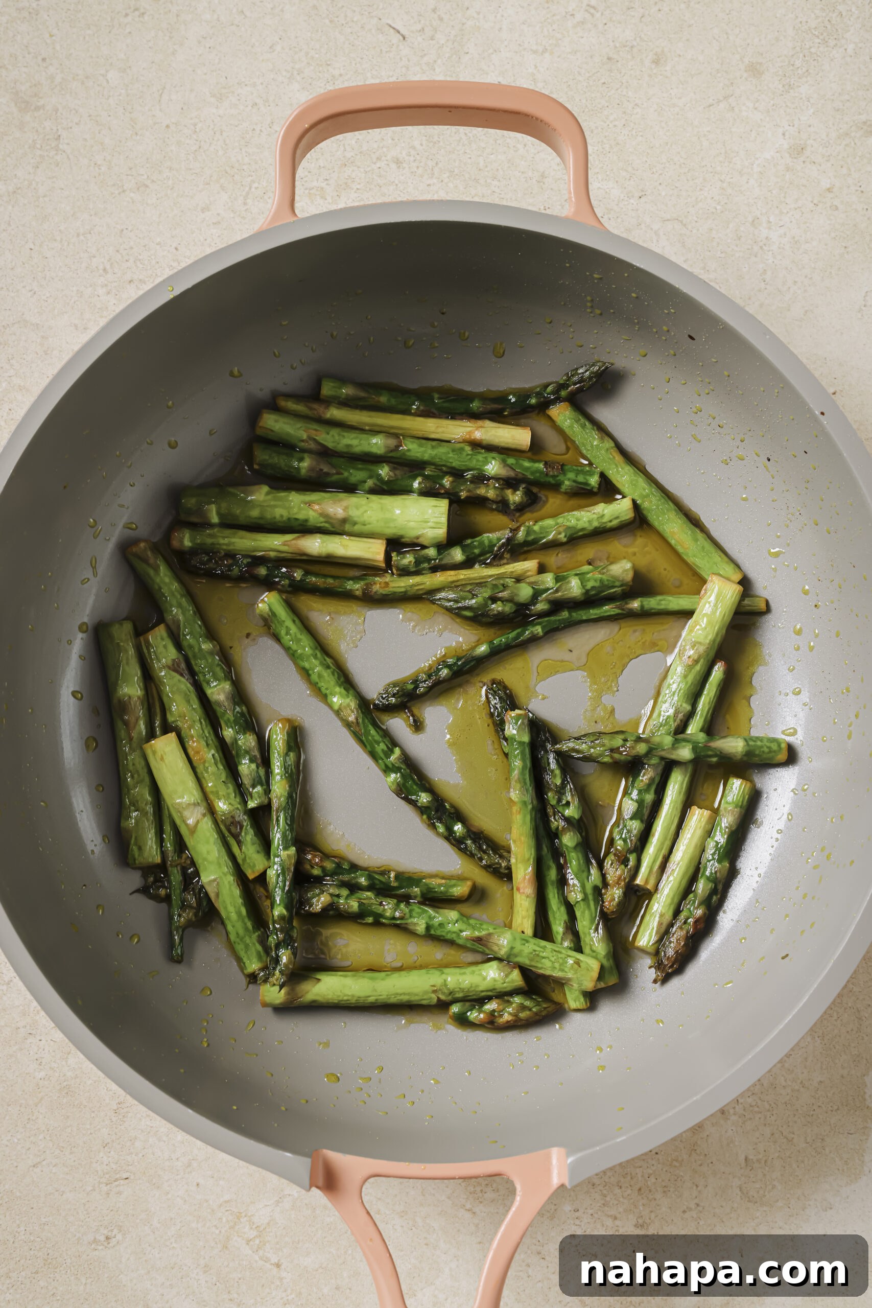 Asparagus being transferred from the pan.