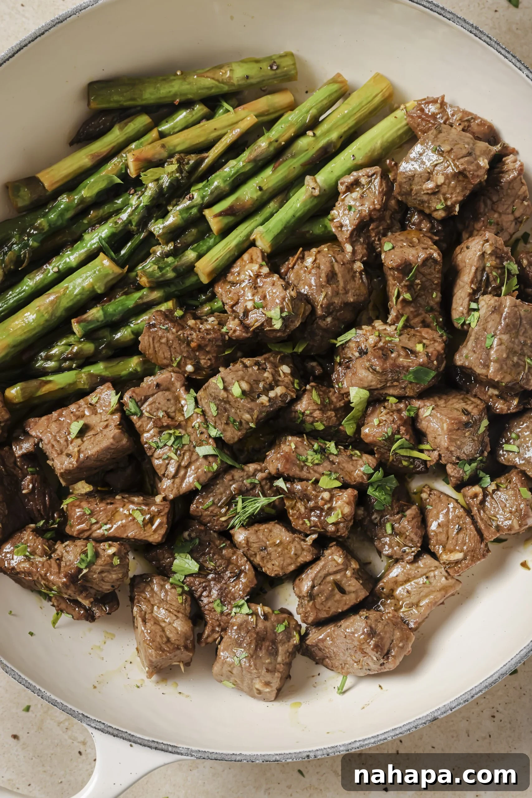 Close-up of Garlic Balsamic Steak Bites with Asparagus