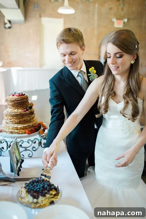 A Paleo Perfection: Our Wedding Crepe Cake and Unforgettable Day 12 Couple cutting their wedding cake.