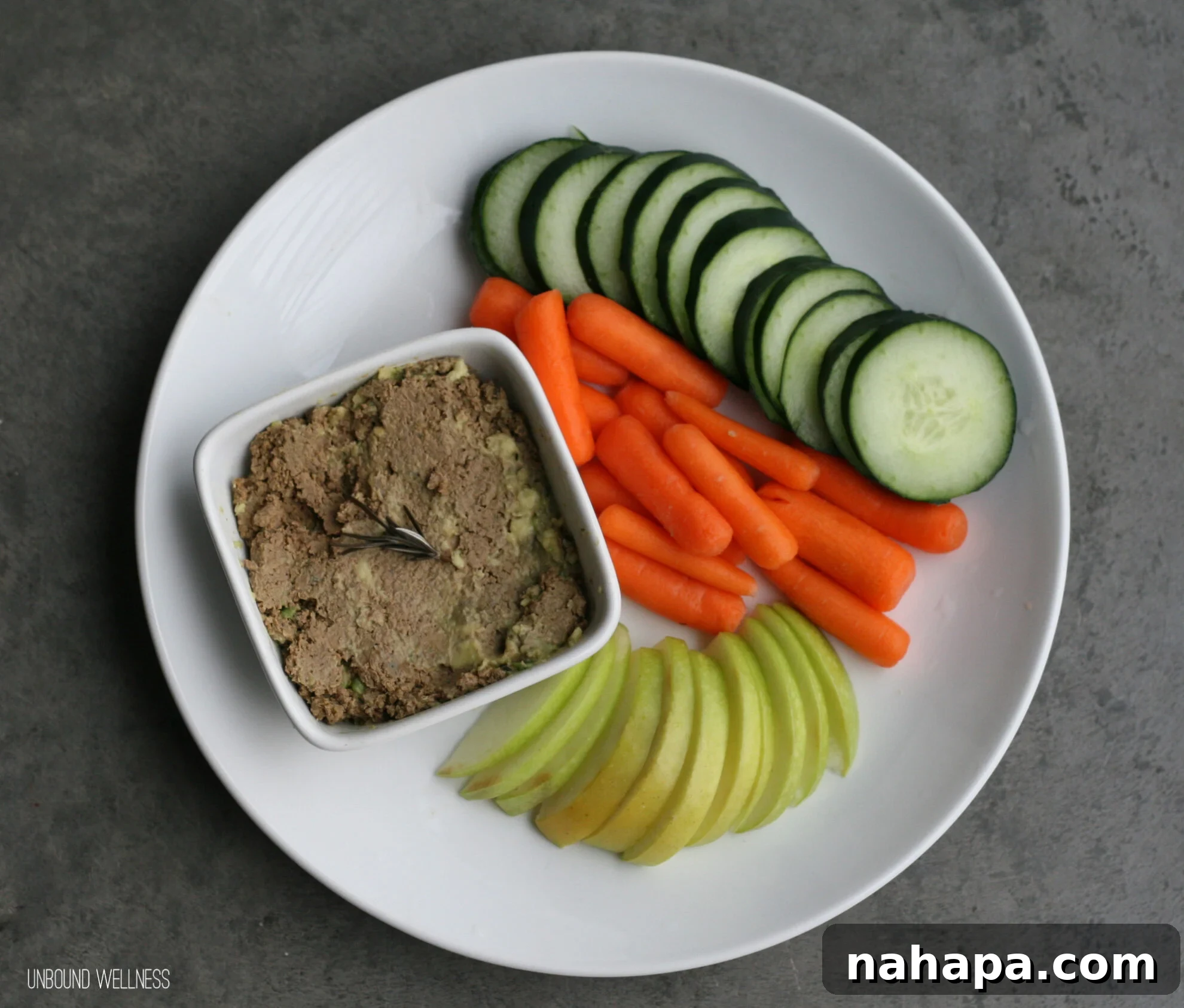 Nutrient Dense Avocado Beef Liver Pâté (paleo and AIP) artfully presented with fresh herbs and a rustic background.