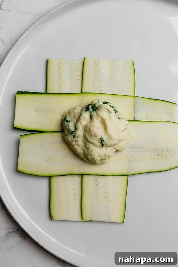 Wholesome Zucchini Ravioli Paleo Keto Vegan Delight 3 The process of layering zucchini slices to form the base of the ravioli before adding the filling.