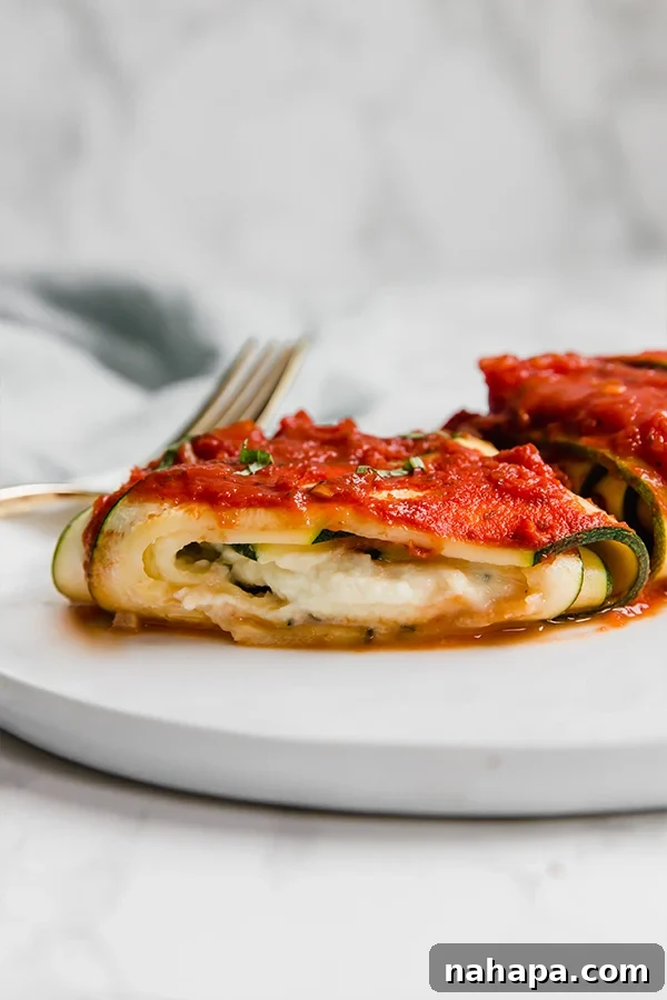 Wholesome Zucchini Ravioli Paleo Keto Vegan Delight 4 Close-up of perfectly baked Zucchini Ravioli with basil garnish, glistening with marinara sauce and ready to be enjoyed.
