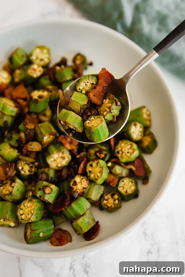 Close-up of freshly cooked Southern Bacon and Okra Skillet, showcasing the tender okra pods and crispy bacon bits, served in a rustic bowl.