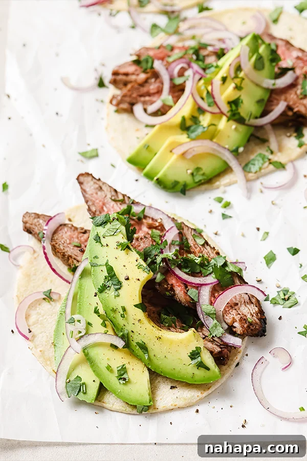 Grilled Carne Asada on a cutting board, ready to be sliced
