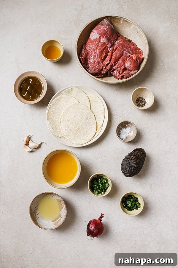 Raw flank steak marinating in a bowl with citrus, garlic, and herbs