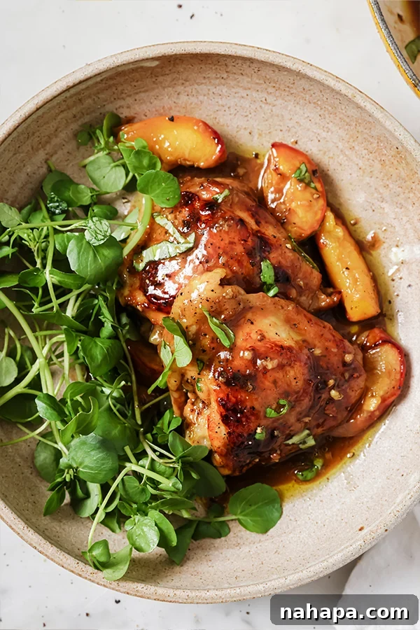 Final presentation of Balsamic Peach Chicken Thighs with fresh basil garnish