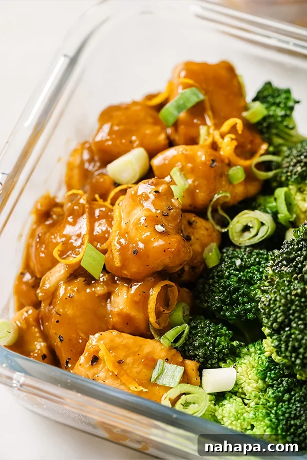 Paleo Whole30 AIP Orange Chicken Make Ahead Meals 5 Assembled orange chicken meal prep bowls with chicken, broccoli, and cauliflower rice