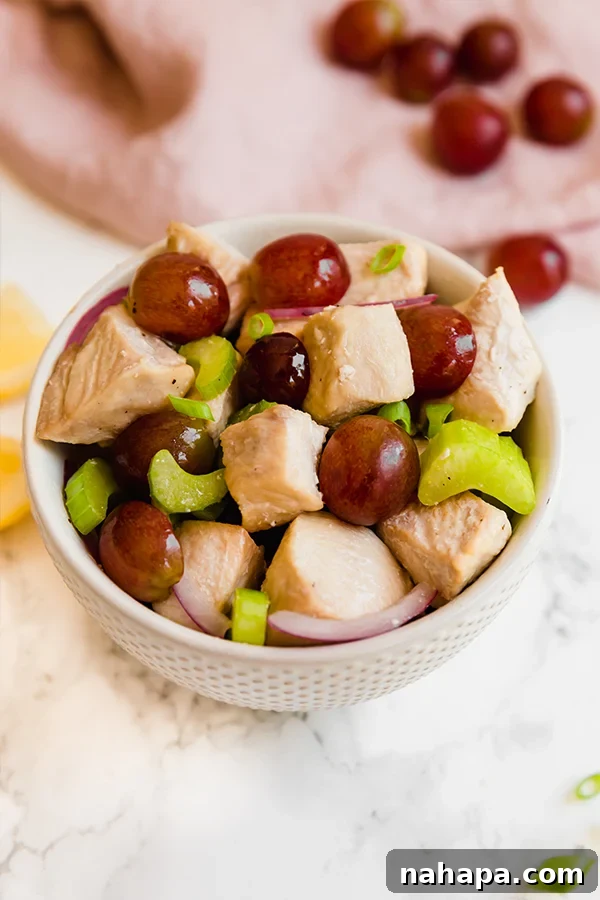 Wholesome No Mayo Chicken Salad Paleo Whole30 AIP 2 A fresh, vibrant white bowl of no-mayo chicken salad with healthy ingredients.