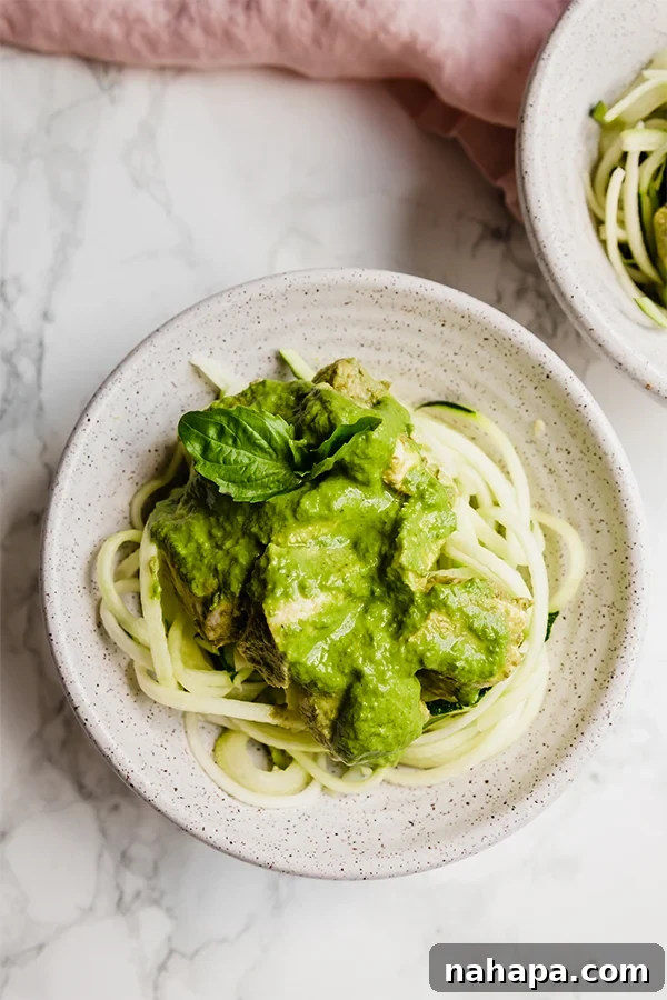 Close-up of Slow Cooker Chicken Pesto served over fresh zucchini noodles
