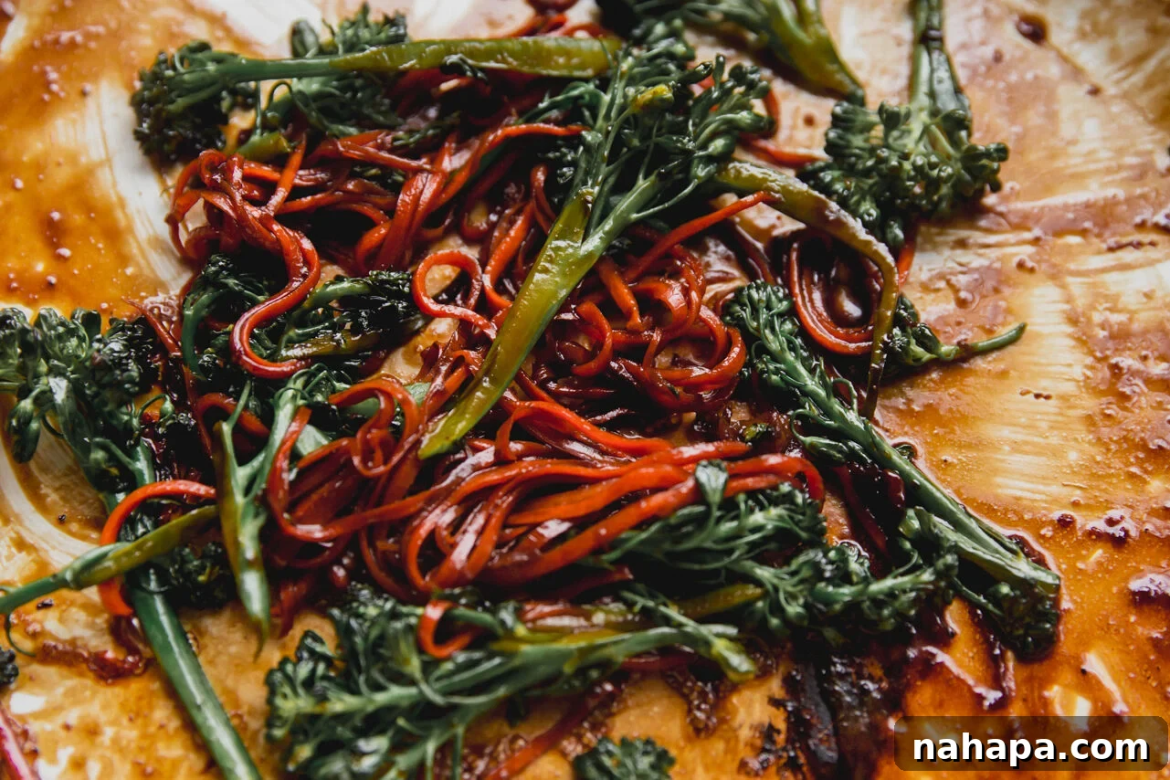 A mix of vibrant broccoli and shredded carrots lightly sautéed in a pan, appearing tender-crisp and perfectly seasoned.