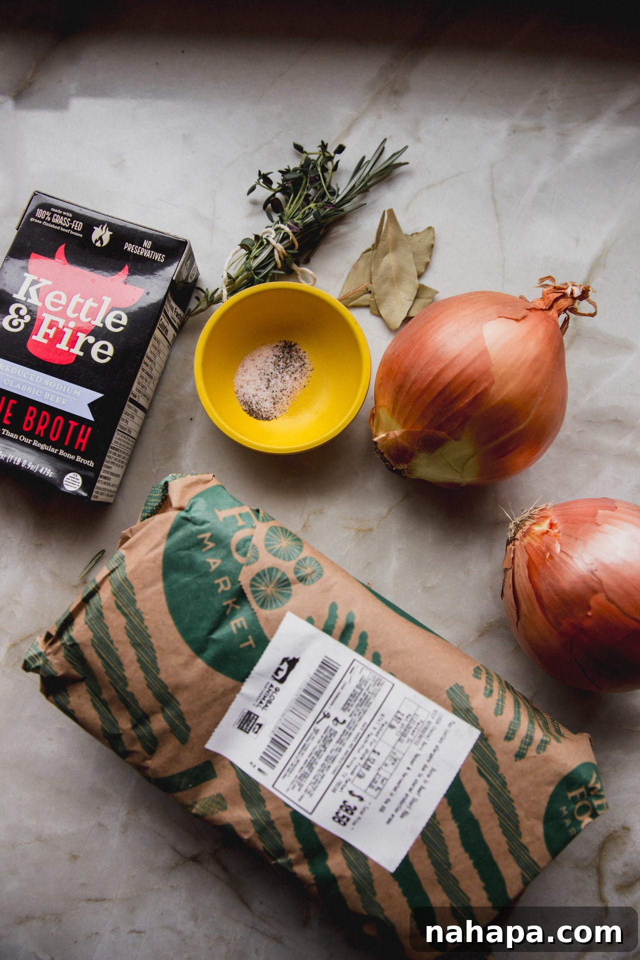 French onion short rib ingredients on a marble counter top.